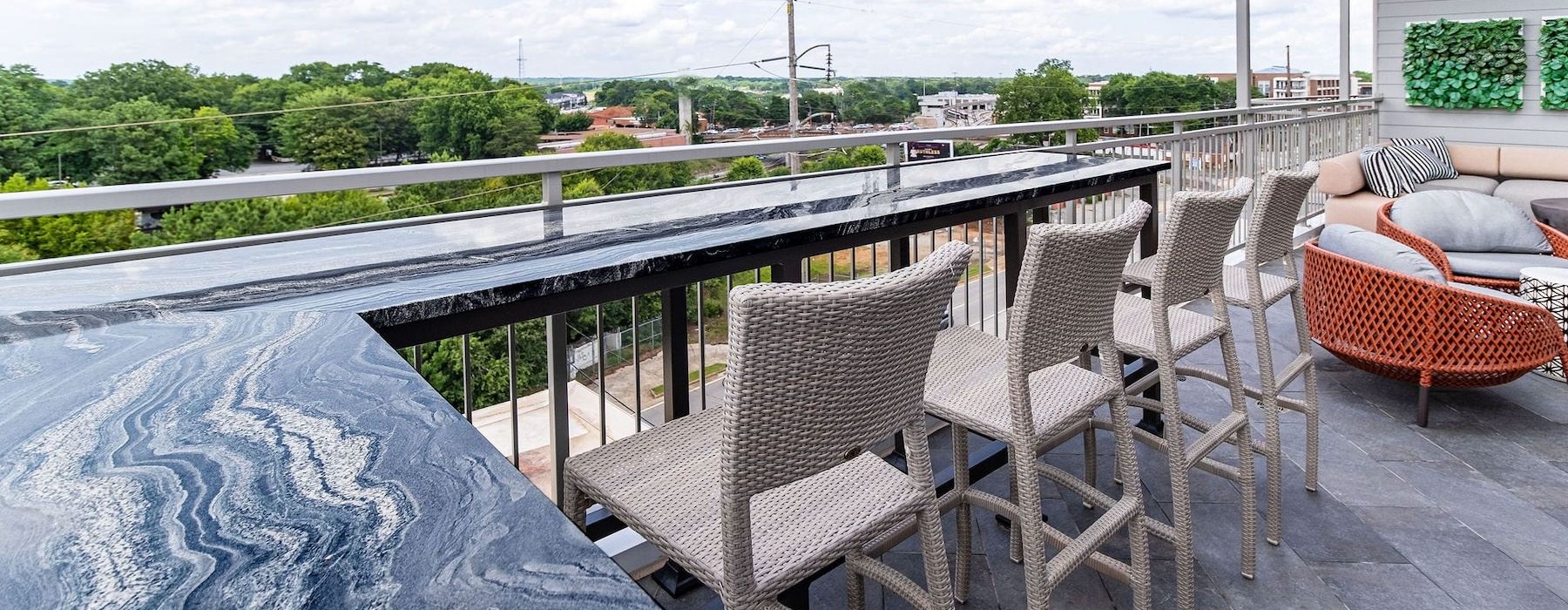 an outdoor lounge area with a table and chairs