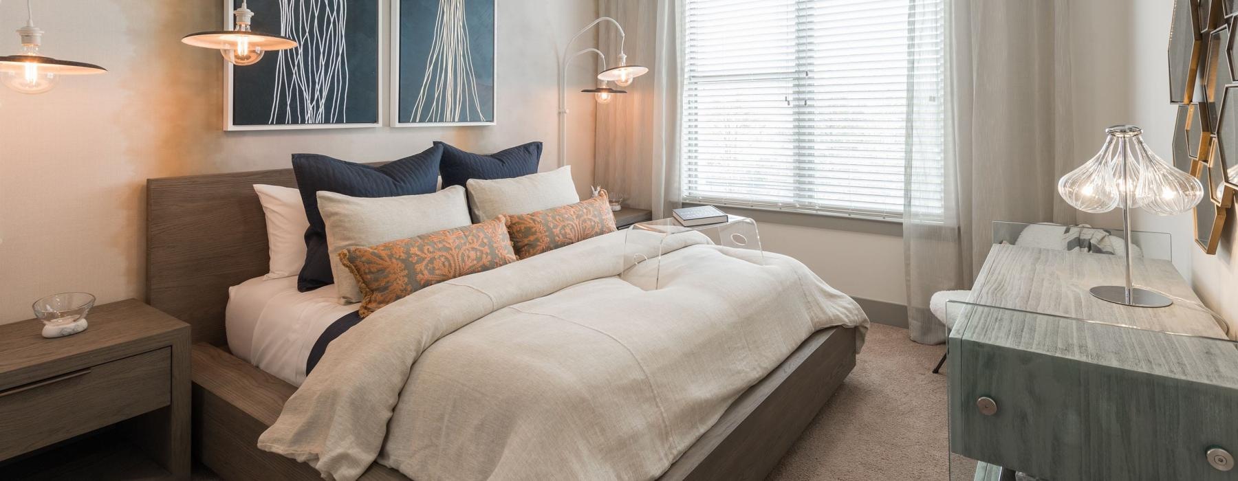 a bedroom with a bed and a fan