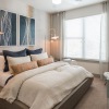 a bedroom with a bed and a fan