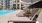 a pool with chairs and umbrellas by it