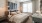 a bedroom with a bed and a fan